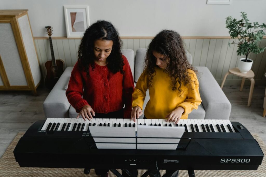 Academia Formacion Musical Rodriguez Madrid - A woman and child playing piano together, enjoying a musical moment.